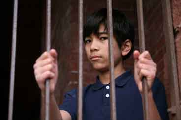 Boy behind bars