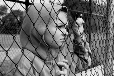 Kid behind fence
